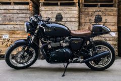 triumph thruxton in front of apple crates